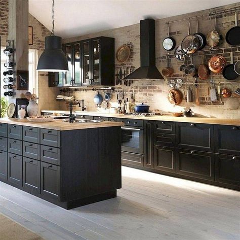 Timeless kitchen with brick walls and black wood cabinets along with wooden countertops - Decoist Backsplash Dark Cabinets, Industrial Kitchen Design Ideas, Kitchen With Brick Wall, Dapur Rustic, Backsplash With Dark Cabinets, Wooden Countertops, Industrial Kitchen Design, Interior Dapur, Brick Kitchen