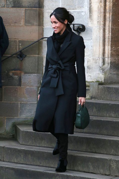 A Classic Black Coat - Every woman needs a classic black coat. Meghan’s structured take is a wardrobe hero whether you replicate her look head to toe with a colored bag and velvet boots or layer over an evening gown with stilettos.Homepage image: Getty Images Evening Coats Women, Black Coat Outfit Women, Chilli Outfits, Black Coat Outfit Winter Classy, Black Coat Outfits For Women, Black Winter Coat Women, Black Wool Coat Outfit, Black Coat Outfit Winter, Long Black Coat Outfit