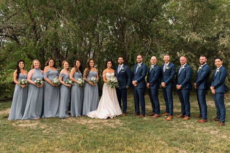 Bridesmaids in dusty blue dresses mismatched. Groomsmen in navy blue suits. See more from this fall outdoor wedding in Fort Collins, CO on the blog. #dustybluewedding Navy Tux With Dusty Blue, Dusty Blue Bridesmaid Dress With Groomsmen, Cornflower Blue Groomsmen, Light Navy Groomsmen Suits, Navy Blue Suit With Dusty Blue Tie, Blue Groom Navy Groomsmen, Groomsmen In Navy Blue, Dusty Navy Bridesmaid Dresses, Navy Blue Tux With Dusty Blue Tie