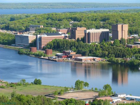 Houghton, MI; home of Michigan Tech. See that T-shaped building on the right? Designers failed to take into account the wind curl that forms there in the winter. Unwary students may be happy there is a cable strung near this building to hold on to when approaching. Houghton Michigan, Michigan Tech, Michigan Sports, College Stuff, State Of Michigan, Upper Peninsula, Mackinac Island, Outdoor Quotes, Northern Michigan