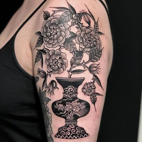 Flowers in dragon pot tattoo by El Dragon #ElDragon #planttattoos #blackandgrey #linework #flowers #plants #leaves #peony #nature #pattern #dots #dragon #Japanese #woodblockstyle #vase #mashup #tattoooftheday Tattoo Flower Peony, Traditional Plant Pot Tattoo, Vase With Plant Tattoo, Chinese Vase Tattoo, Plant Pot Tattoo, Japanese Vase Tattoo, Japanese Dragon And Flowers Tattoo, Flower Pot Tattoo, Dragon Vase Tattoo