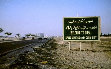 Welcome to Dubai sign with Wilson Building in distance Dubai 1990, Welcome To Dubai, Dubai Photos, Random Posters, History Uae, Old Dubai, Uae Flag, Dubai World, Building Signs