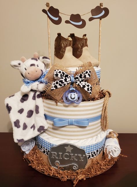 Cowboy themed baby shower centerpiece gift. Visit my Facebook page for more pictures and orders. https://m.facebook.com/adorablegifts Cowboy Theme Baby Shower Cake, Baby Shower Themes Western, Cowboy Shower Ideas, Holy Cow Baby Shower Theme Boy, Cowboy Themed Cake, Highland Cow Diaper Cake, Cowboy Baby Shower Centerpieces, Little Cowboy Baby Shower Ideas, Western Baby Shower Ideas For Boys