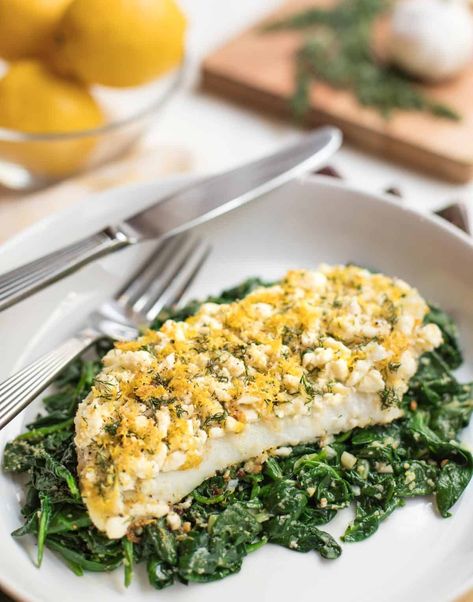 Roasted Cod on Spinach with Feta,Lemon and Dill is healthy, quick and easy. Cod fillets topped with fresh feta cheese, lemon zest and dill, are roasted and served atop sauteed garlicy spinach. #codrecipe #easyfishrecipes #roastedfishdishes #spinachrecipes #healthyrecipes Oven Baked Cod, Grilled Cod, Roasted Cod, Cod Fillets, Spinach Benefits, Cod Fish Recipes, Dill Recipes, Lemon Dill, Easy Fish Recipes