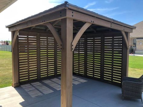 Yardistry's 12 ft. Privacy Wall is the perfect complement to your existing Yardistry 12 x 12, 12 x 14 or 12 x 16 Wood Gazebo with Aluminum Roof. Whether you’re looking for some shade, protection from the wind, or a little privacy, Yardistry’s unique privacy wall design has you covered. Pergola Wind Break, Gazebo With Privacy Screen, Diy Pergola Privacy Wall, Privacy Gazebo Ideas, Covered Deck With Privacy Wall, Gazebo Privacy Wall Ideas, Hot Tub Pergola Ideas Privacy Walls, Patio Cover With Privacy Wall, Gazebo Enclosure Ideas