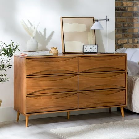 Add a stylish and practical dresser to your home with the Walker Edison 58 Mid-Century Modern Curved Front 6-Drawer Dresser. This eye-catching dresser features unique, curved detailing on the front of the drawers, which gives it a retro-inspired look that is sure to stand out. The tapered legs add an extra touch of style, while the six spacious drawers provide plenty of room for storing the essentials. Made from responsibly harvested solid pine wood, this dresser is both environmentally friendly and long-lasting. Color: Brown. Designer Dresser Furniture, Mid Century Modern Bedroom Dresser, Mcm Bedroom Furniture, Walnut Dresser Bedroom, Retro Dressers, Affordable Dresser, 70s Dresser, Glam Bedroom Inspirations, Bedroom Dresser Decor Ideas