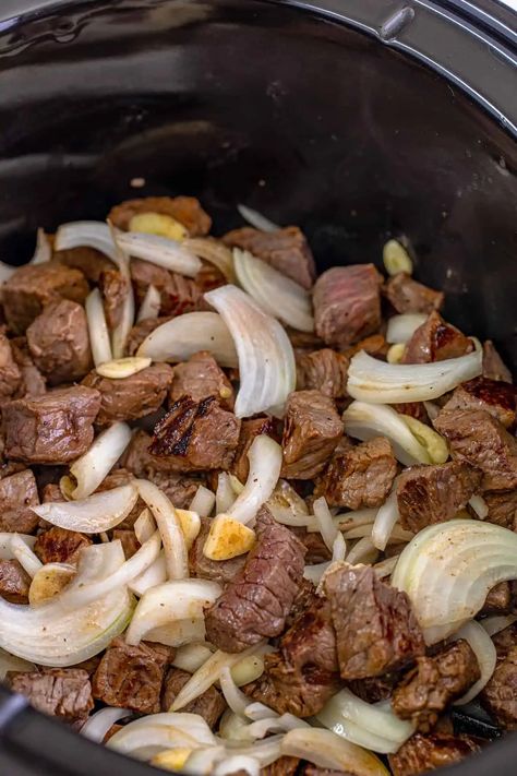 These crockpot steak bites will become a new family favorite. Tender bites of steak are perfectly seasoned and slow cooked with garlic, onions, and au jus gravy mix for a mouthwatering dish that's easy enough for any day of the week. #steakbites #crockpotmeals #slowcookerrecipes Recipes With Sirloin Tip Steak, Sirloin Crockpot Recipes, Slow Cooker Steak And Potatoes, Crockpot Steak Bites, Garlic Butter Steak Bites, Butter Steak Bites, Crockpot Steak, Filet Mignon Recipes, Garlic Steak