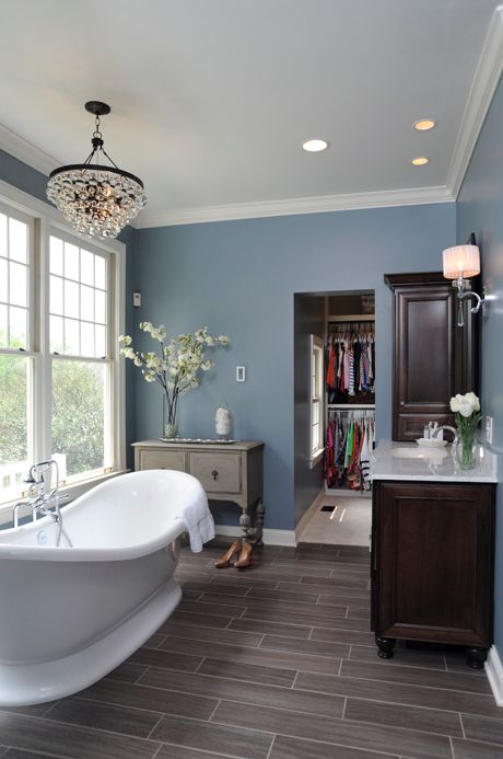 Bathroom remodel with porcelain tile floor, blue walls, freestanding tub and chandelier designed by Dave Fox Design Build Remodelers. #davefox #housetrends Makeover Kamar Mandi, Blue Bathrooms Designs, Gray Tile, Best Kitchen Design, Grey Wood Floors, Large Bathroom, Gray Bathroom, Grey Bathroom, Bathroom Color