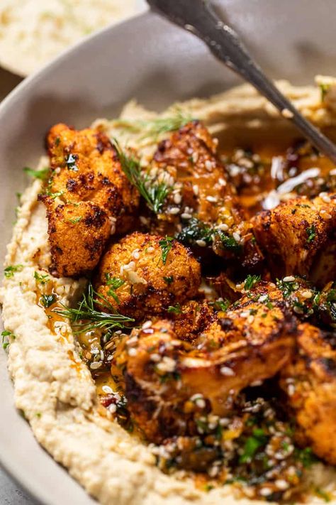 Veggie Hummus Recipe, Moroccan Roasted Cauliflower, Hummus Dishes Lunches, Roasted Cauliflower Bowl Recipes, Roasted Cauliflower Meals, Hummus And Roasted Vegetables, Mediterranean Veg Recipes, Cauliflower Recipes Vegetarian, Mediterranean Roasted Cauliflower