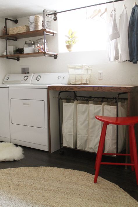 basement laundry room -- I like the simplicity of this room, the wooden folding table, the shelves over the washer/dryer, the drying rack, the laundry sorter under the table (genius, then you don't have to see the messy laundry!), and the bright red stool Functional Basement, Laundry Room Organization Storage, Casa Clean, Room Storage Diy, Basement Laundry Room, Basement Laundry, Laundry Room Bathroom, Farmhouse Laundry Room, Small Basements