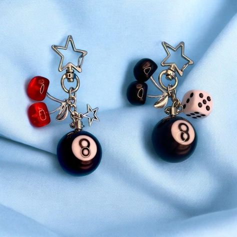 Bring back the fun and funky vibes of Y2K with our Number 8 Ball, Cherry, Dice & Star Keychain! This handmade, creative accessory is a nostalgic nod to early 2000s fashion, combining iconic symbols like the classic 8-ball, playful cherries, lucky dice, and a sparkling star. Perfect for adding a pop of retro flair to your keys, bags, or phone, this keychain is a must-have for anyone who loves the bold and eclectic style of Y2K. Crafted with attention to detail, this keychain is made from high-qua Eight Ball Keychain, 8 Ball Earrings, Y2k Trinkets, Chunky Keychain, Funky Keychains, 8 Ball Keychain, Trendy Keychain, Funky Vibes, Telephone Retro