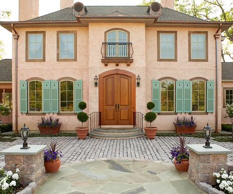 Peach terra-cotta and muted green make a unique color scheme on this symmetrical home. See more home exteriors: http://www.bhg.com/home-improvement/exteriors/?socsrc=bhgpin092212peachterracotta Exterior Color Combinations, Green Shutters, Best Exterior Paint, House Paint Color Combination, European Doors, Door Exterior, Stucco Homes, French Style Homes, Mediterranean Style Homes