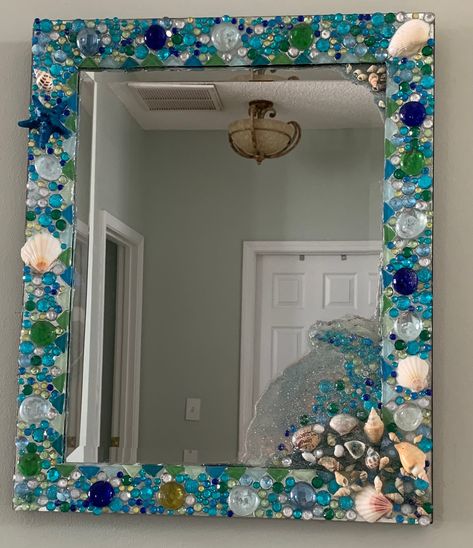 Hand crafted mirror with jewels and seashells incased in resin, one of a kind mirror. Mermaid Bathroom Ideas Diy, Seashell Mirror Diy, Plastic Spoon Mirror, Seashell Bathroom Decor, Crystal Mirrors, Decorated Mirrors, Seashell Mirrors, Diy Mirrors, Beach Mirror