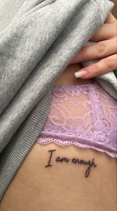 Welcome to the world of the ‘I am enough’ tattoo, a design that speaks volumes. This design is not just a fleeting trend. It serves as a powerful affirmation, a daily reminder of your intrinsic worth. No Tattoo Quotes, Your Enough Tattoos For Women, She Is Enough Tattoo, Tattoos For Self Confidence, Love Yourself Back Tattoo, Tattoo For Body Confidence, I Am Enough Rib Tattoo, Body Empowerment Tattoos, Tattoos To Keep You Going