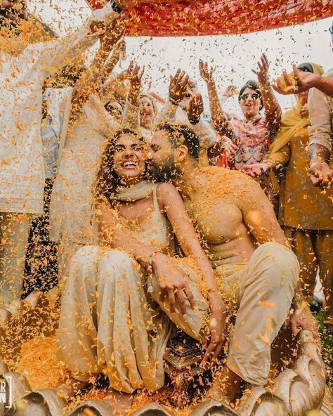 Check out the best haldi ceremony tip for your wedding day: throw petals! Not only do you get the most aesthetic wedding pictures, but it's also the best way to get your guests involved. Check out our blog for more of the best Indian wedding tips. Poses For Haldi, Haldi Brides, Haldi Photoshoot Poses, Poses For Bride, Haldi Photoshoot, Haldi Ceremony, Survival Guide, Photoshoot Poses, Bride Groom