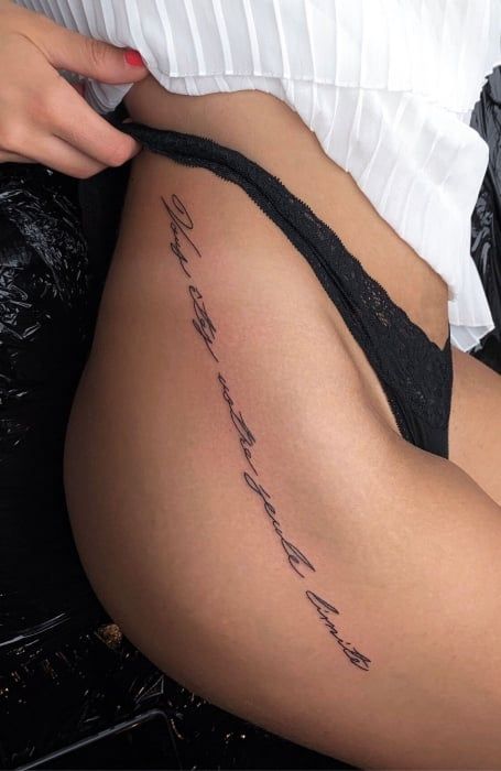 50 Sexy Hip Tattoos for Women (2023) - The Trend Spotter Words Down Hip Tattoo, Quote Hip Tattoo, Cursive Thigh Tattoo, Side Hip Tattoos Women Quotes, Hip Quote Tattoo, Cursive Tattoos For Women, Word Thigh Tattoo, Thigh Quote Tattoo, Hips Tattoo