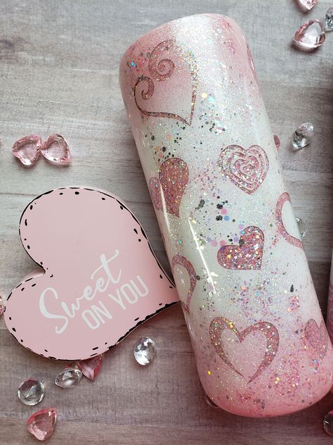 This beautiful sweetheart tumbler is sure to spark the love for yourself or that special someone. This tumbler comes with multiple peek-a-boo hearts and the sparkle of lots of glitter. The pink and white ombre is absolutely beautiful. My favorite color is pink and I believe this is one of the prettiest tumblers I have ever made. All my tumblers come with a sliding lid and a reusable straw. This tumbler can also be personalized with your name or a special heart with your name and that special som Pink And White Glitter Tumbler, Pink Glitter Epoxy Tumbler, Prettiest Tumblers, Girly Tumbler Cups, Resin Cups Ideas, Glitter Cups Tumblers, Heart Tumblers, Peekaboo Tumbler, Pink Glitter Tumbler