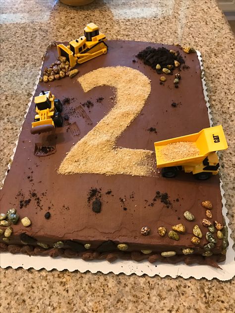 2nd birthday construction cake. Sheet cake was bought at supermarket. Candy rocks, construction toys purchased on Amazon. Graham crackers and chocolate wafer dirt. Construction Theme Birthday, Construction Birthday Cake, Construction Theme Birthday Party, Dump Truck Birthday, Construction Cake, Truck Cakes, Construction Trucks, Construction Birthday Parties, Trucks Birthday Party