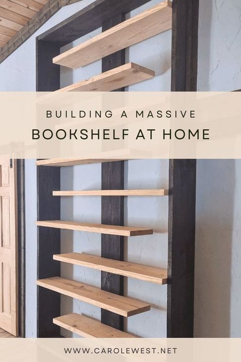 A year later and I still love this massive bookshelf my husband built as a focal point for our simple home. It holds our books, video and games and even a few other odds and ends. This is an easy project with simple steps if you are into DIY. Heavy Duty Bookshelves, Easy Library Shelves, Diy Whole Wall Bookshelf, Library Organization Ideas Home, Fyi Bookshelves, Diy Bedroom Bookshelves, Homemade Bookshelf Ideas, Diy Bedroom Bookshelf, Hanging Bookshelf Diy