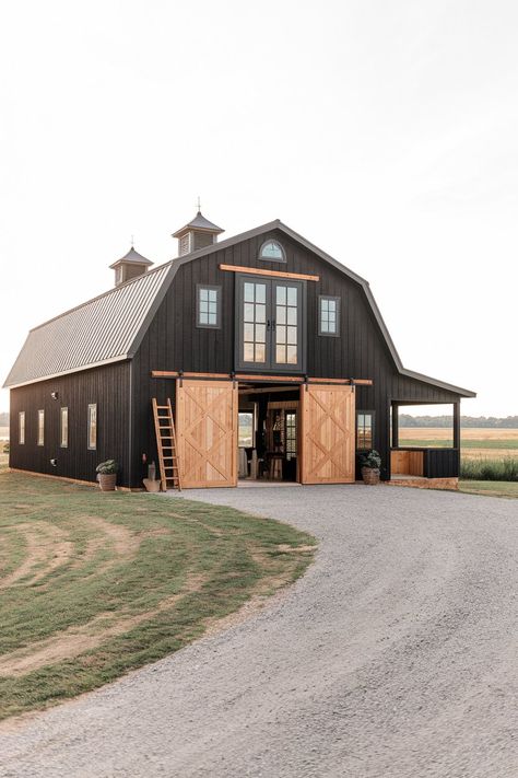 Barndominiums offer a unique blend of rustic charm and modern design. Their versatility makes them ideal for various purposes, from living spaces to functional barns. Black barndominiums, in particular, have gained popularity for their sleek, bold look that complements natural surroundings. In this article, we’ll explore different black barndominium exterior ideas that showcase a range… Horse Ranch Exterior, Horse Barndominium Ideas, Small Barndominium Ideas Interiors Farmhouse, Barndominium Ideas Exterior Rustic, Barndominium Aesthetic, Barndominium Wrap Around Porch, Gray Barndominium Exterior, Dark Barndominium Exterior, Barn Colors Scheme Exterior