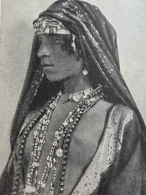 Wearing an embroidered head shawl, worn over a bejewelled turban, necklace of coins, earrings and coloured strings. Picture taken from the book People of all Nations. Arab Hat, Egyptian Headdress, Egyptian Hairstyles, Egypt Vintage, Crimson Knight, Egyptian Aesthetic, Egyptian Accessories, Egyptian Clothing, 90s Runway Fashion