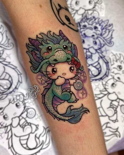 𝓛𝓮𝓪 𝓛𝓲𝓰𝓸𝓽 🌸✨ on Instagram: "glittering bb dragon Hello Kitty for Kaylee partially inspired by their love for Hello Kitty and their zodiac animal! 🐉 ⭐️ I always thought year of the dragon was so badass, especially being born in the year of the rooster 🥴 but I'd love to make more Hello Kitty dress-up tattoos either in the rest of the lunar zodiac animals or anything creative and cute! ☺️💖 ___ Location: top of right forearm Approx. time: 2.5 hours" Hello Kitty Year Of The Dragon, Dragon Cute Tattoo, Glitter Tattoos Real, Tatuajes Hello Kitty Tattoos, Year Of The Dragon Tattoo, Hello Kitty Tattoo Design, Tattoo Hello Kitty, Sanrio Tattoos, Hello Kitty Tattoo Ideas