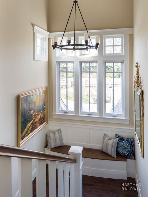 This stunning Hampton's style home boasts a charming addition - a window seat built into the staircase landing. The nook catches natural daylight from the tall windows, offering an ideal spot to feature art and decor to be enjoyed between the two floors of the home. Whether seeking a corner to cozy up with a book or a unique spot to chat, this window seat is sure to become a favorite spot in this beautiful Southern California home. Southern California Home, Staircase Landing, Hamptons Style Home, Stair Well, Double Window, Shingle Style Homes, Tall Windows, Stair Landing, Innovative Architecture