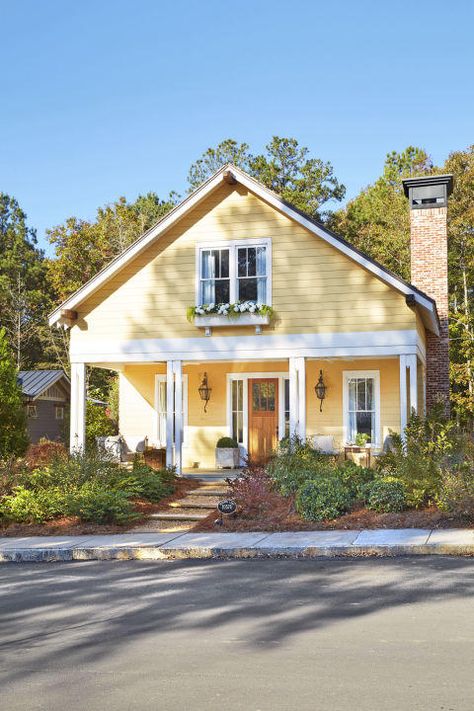 Serenbe, Georgia | Homeowners who aren't afraid of splashes of bright hues. You’ve probably already noticed how color can completely change and revamp a city. Just take a look at the Rainbow Row district in Charleston, South Carolina. The tourist attraction and postcard fixture draws crowds from all over to take in the beautifully-hued series of private Antebellum-style homes lining the street. It’s obvious designers of the Victorian era embraced color palettes. House With White Trim, Yellow House Exterior, Yellow Cottage, Cottage Exterior, Yellow House, Casas Coloniales, Yellow Houses, Casa Exterior, Farmhouse Exterior