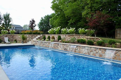 Retaining Wall For Pool, Pool Landscaping With Retaining Wall, Pools With Retaining Walls Design, Inground Pool With Retaining Wall, Pool With Retaining Wall Sloped Backyard, Pool Retaining Wall Ideas, Pools With Retaining Walls, Pools With Retaining Walls Sloped Backyard, Outdoor Feature Wall Ideas