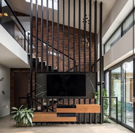 Tv In Front Of Stair Railing, Staircase And Tv Unit Design, Staircase With Tv Living Rooms, Tv Infront Of Stairs, Tv Staircase Wall, Tv Wall Stairs, Partition Wall With Tv, Tv On Staircase Wall, Small Living Room With Stairs