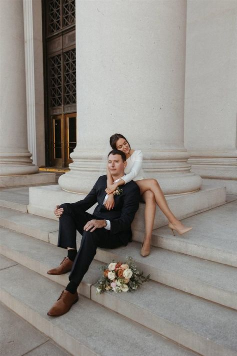 Bride and groom posing for editorial style elopement photos at the Denver Probate Courthouse in Downtown Denver, CO. Bride is wearing a short off shoulder dress by Sarah Seven, with a modern fall bridal bouquet by Beet & Yarrow. Short Off Shoulder Dress, Courthouse Marriage, Editorial Elopement, City Engagement Pictures, City Hall Wedding Photos, Courthouse Wedding Photos, Wedding Portrait Poses, Cute Engagement Photos, Couple Engagement Pictures