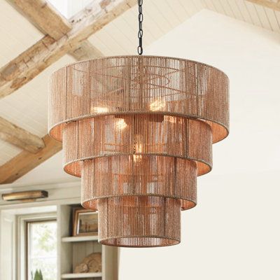 This 26-inch 5-light pendant light is inspired by a coastal aesthetic to add a feature to your setting. The woven rattan shade is made up of four different-sized circular hollow cages, which diffuse the light through its striped rattan pattern. Use this handcrafted pendant chandelier over your dining table or any sitting area in your space for a warm glow. Finish: Brown | Bayou Breeze Aleris 5 - Light Shaded Tiered Pendant, Rattan | Wayfair Extra Large Boho Chandelier, Wicker Light Fixture Dining Rooms, Huge Chandelier High Ceilings, Large Beaded Chandelier, Oversized Foyer Chandelier, Large Rattan Chandelier, Coastal Chandelier Bedroom, Coastal Dining Room Lighting, Rattan Aesthetic