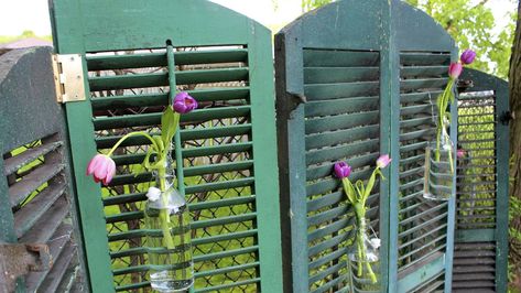 We had three pairs of old shutters and didn't know what to do with them. So we created a privacy screen a couple years ago and this year took it apart and hung the pairs on a long fenceline to create some interest. #Salvaged #GardenFeature #GardenDecor Old Wooden Shutters, Neat Garden, Rustic Eclectic, Shutter Decor, Vintage Shutters, Propane Tanks, Garden Globes, Diy Shutters, Diy Garden Fountains