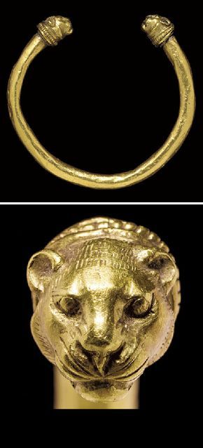 A GREEK GOLD BRACELET CLASSICAL PERIOD, CIRCA 5TH CENTURY B.C. The penannular hoop round in section, with lion-head terminals joined to the ends by a cylindrical collar, a small beaded wire at the join, a larger beaded wire framed by plain wire behind the heads, each lion head with an incised radiating mane, the short rounded ears high on the head, the eyes bulging within the recessed sockets, the whiskers incised 3¼ in. (8.3 cm.) wide Greek Artifacts, Dragon Heads, Ancient Greek Jewelry, Ancient Jewels, Ancient Jewellery, Classical Period, Historical Jewellery, Art Ancien, Greek Jewelry