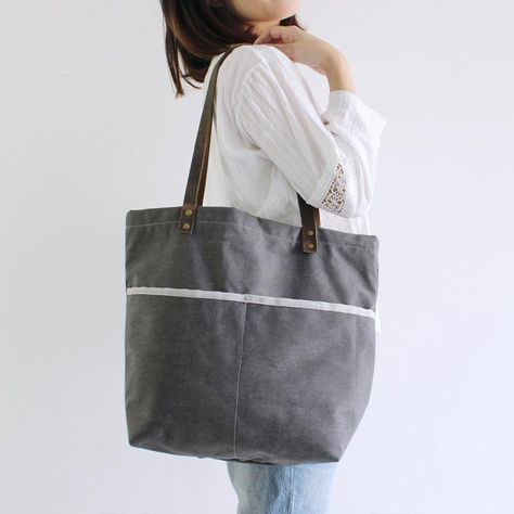 A beautiful large handcrafted canvas tote with plenty of room. A zippered top secures the bag. Perfect for shopping, weekend getaways or a trip to the farmers market. - Long Handle Drop - 2 interior slip pockets - Zippered interior pocket - 17.7 x 15.7 x 4.7 (inches) - Striped cotton lining School Purse, Laptop Handbag, Grey Tote, Badass Style, Leather Duffle Bag, Purse Vintage, Bag School, Leather Duffle, Monogram Tote