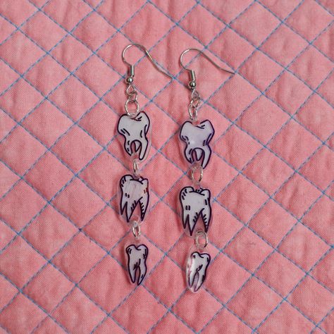 Hand drawn teeth illustrations on shrink dink plastic. Shrinkie Dink Ideas, Weird Jewelry Aesthetic, Shrink Dink Ideas, Shrinks Dink Earrings, Shrinks Dink Ideas, Cute Shrinky Dink Ideas, Shrink Plastic Ideas, Shrink Earrings, Shrinky Dink Charms