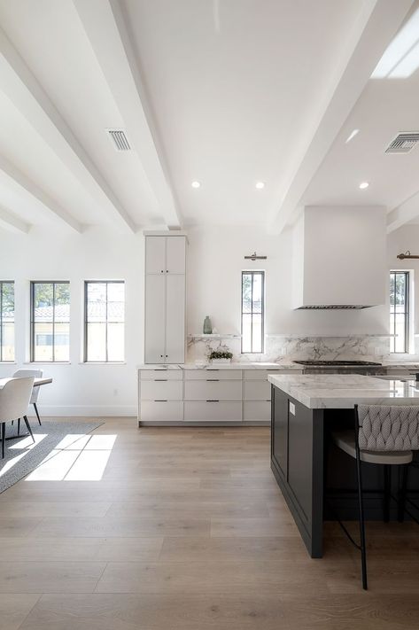 The drywall wrapped beans adorn the 10 foot ceilings in the 14th Street Project, and are a detail that really elevated the design in the living area! 🏠 See the full project reveal on KeeleyToroDesign.com Contemporary Ceiling Beams, Wrapped Beams Ceilings, White Beams In Kitchen, 11 Foot Ceilings Kitchen, Drywall Beams Ceiling, 12 Foot Ceilings Kitchen, Ceiling Transition Between Rooms, Kitchen 10 Foot Ceiling, Volted Ceiling Ideas