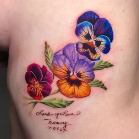 Discover the Charm of February Birth Flower Tattoos: Violets & Primroses Ink Ideas Petunia Tattoos For Women, Blue Pansy Tattoo, Small Flower Tattoo Color, Pansie Flower Tattoo, Lutos Flower Tattoo, Purple Pansy Tattoo, Floral Memorial Tattoo, Snapdragon Flowers Tattoo, Rainbow Flower Tattoo