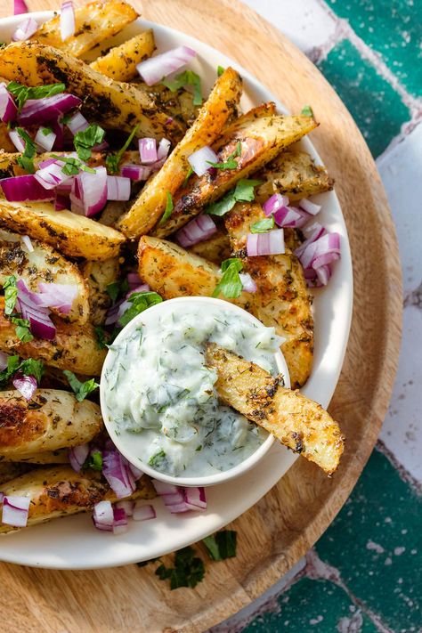 These Vegan Greek Fries are loaded with toppings. Fresh parsley, red onion, and vegan feta. They're crispy on the outside and tender on the inside. These fries are made with loads of dried herbs so they're full of flavors. I highly recommend dipping them on Tzatziki sauce (vegan or regular). Great as a side to Mediterranean dishes or on their own. Tzatziki Sauce Vegan, Vegan Cheddar Cheese Sauce, Bacon Cheese Fries, Greek Fries, Fries At Home, Vegan Feta, Vegan Greek, Homemade Tzatziki Sauce, Vegan Feta Cheese