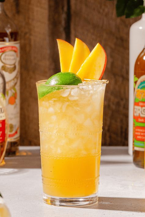 This Mango Mai Tai is a delicious spin on the classic Mai Tai Tiki cocktail. Tropical mango pairs perfectly with aged rum and fresh lime, and it makes for a perfect summer drink. Orange Curaçao liqueur and orgeat syrup round out the flavors. If you've never had a true Mai Tai before, you're in for a treat with this twist on the original Trader Vic recipe! Mango Nectar Recipes, Rum Runner Recipe, Curacao Drink, Mango Mai Tai, Mango Cocktail, Mango Rum, Tiki Cocktail, Good Rum, Perfect Summer Drink