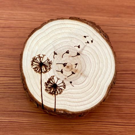 "This set of laser engraved wood coasters is the perfect way to show off your love of this flower! A great gift for new homeowners, anniversaries, birthdays, or Christmas. Each wood coaster features a dandelion illustration laser engraved on the top. The engraved wood coasters are 3.5\"- 4\" in diameter and 3/8\" thick. The wood slice coasters compliment any living space quite well, regardless of style. The unfinished surface of the wood slices makes the perfect coaster, keeping furniture safe f Wood Burned Dandelion, Wood Burning Ideas Patterns, Wood Burning Coasters, Coaster Design Ideas, Dandelion Illustration, Wood Slice Coasters, Personalized Wood Coasters, Engraved Wood Coasters, Bird Coasters