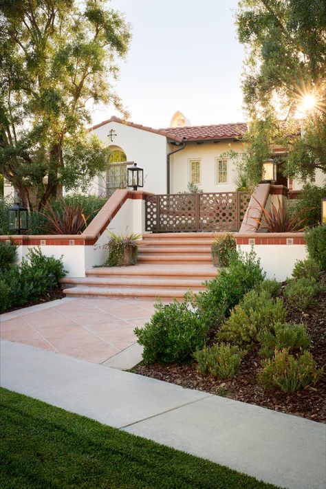 Building off the idea of the traditional Spanish courtyard, the front yard of this home has been updated with a Mediterranean plant palette, new LED lighting, and custom iron gates. Spanish Style Driveway Pavers, Hill Backyard, Custom Iron Gates, Spanish Courtyard, Plant Palette, Front Fence, Mediterranean Plants, Paver Driveway, Landscape Architects