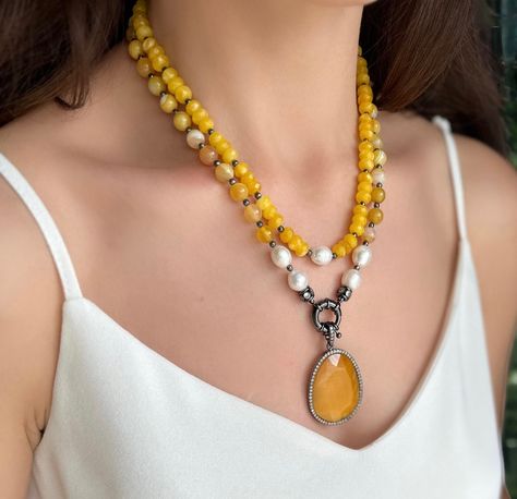 Handmade yellow agate and pearl necklace for women. Elevate your style with our exquisite handmade yellow agate and pearl necklace designed for women. Each piece is crafted with precision and care, blending the natural beauty of agate with the timeless elegance of pearls. Make a statement with this unique and captivating accessory, perfect for any occasion. Embrace the artistry of handcrafted jewelry and adorn yourself with this stunning yellow agate and pearl necklace. I use these pieces: - 8 m Yellow Gemstone Necklace, Jewelry With Crystals, Christmas Gift For Girlfriend, Yellow Agate, Pearl Necklace Designs, Christmas Gifts For Girlfriend, Necklace For Her, Yellow Gemstones, Handmade Fashion Jewelry