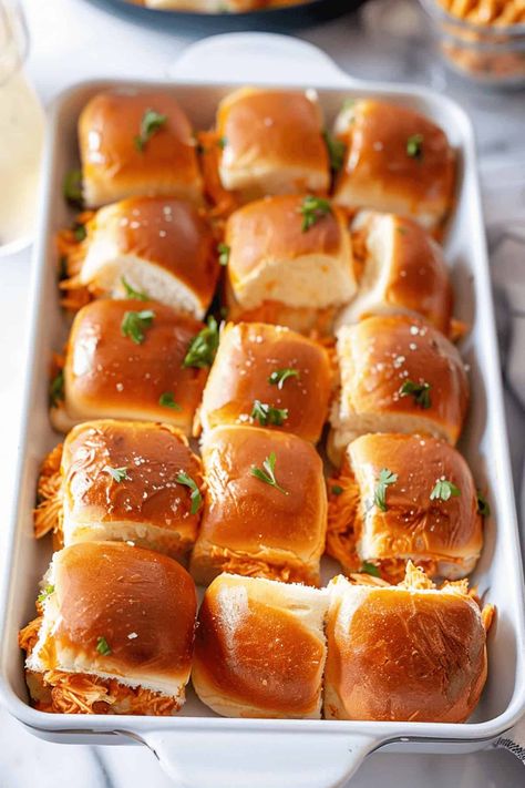 Buffalo Chicken Sliders are an easy game day sandwich! They take just 5 ingredients and 5 minutes before letting your crock pot do the work. Half Baked Harvest Buffalo Chicken Sliders, Kings Hawaiian Buffalo Chicken Sliders, Buffalo Chicken Sliders Crock Pot, Buffalo Sliders, Buffalo Meatballs, Slow Cooker Buffalo Chicken, Buffalo Chicken Dip Crock Pot, Hot Sandwiches, Hawaiian Roll Sliders