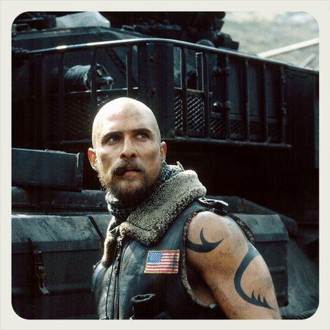 Reign of Fire (2002) Directed by Rob Bowman. Matthew McConaughey as  Denton Van Zan. McConaughey's character appears 30 minutes into the… Reign Of Fire Movie, Celebrities Reference, Justice League Cast, Reign Of Fire, Door Mouse, Apocalypse Au, Bald With Beard, Omega Man, Meet Guys