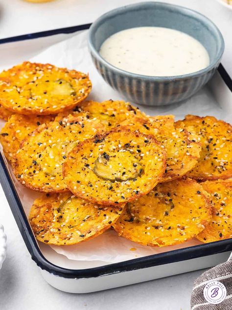 Made with just 3 ingredients, these Dill Pickle Cheddar Cheese Chips are an easy, low carb snack idea. They're a nice alternative to potato chips when that salty craving hits - ready in 15 minutes. Cheese Pickle Ranch Appetizer, Pickle In Cheese, Oven Baked Pickles With Cheese, Dehydrated Pickle Chips, Fried Cheese And Pickles, Keto Cheese Pickle Chips, Dill Pickle Crackers, Cheese Pickles Oven, Dill Pickle Snack Ideas