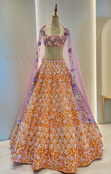 The Marigold Lehenga set is intricately embroidered with love. The dreamy Lehenga can be paired with lavender embroidery on orange raw silk top.The Lehenga is paired with flower embroidery lavender net dupatta.DELIVERY TIMEPlease allow 8-12 weeks for your outfit to arrive.FABRIC DETAILSPure Raw Silk top and lehenga Soft Net DupattaProfessional cleaning only. Lavender Lehenga, Top And Lehenga, Lehenga Ideas, Tops Indian, Lavender Embroidery, Girls Lehenga, Indian Dress Up, Orange Lehenga, Eastern Fashion