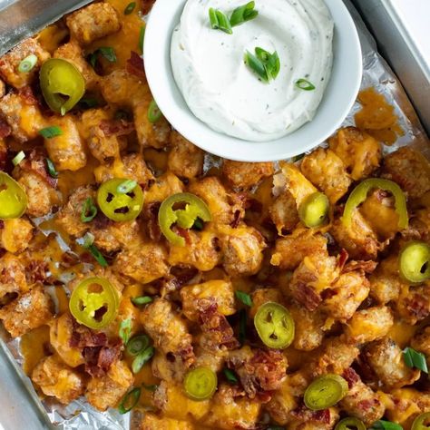 Crispy tater tots are dusted with ranch seasoning, topped with cheddar cheese and crumbled bacon, and broiled until melty for perfect party food, like on game days! Ranch Sour Cream, Church Potluck Recipes, Homemade Tater Tots, Sweet Potato Tater Tots, Loaded Tater Tots, Tater Tot Recipes, Balsamic Pork, Cheeseburger Soup, Salad Pasta