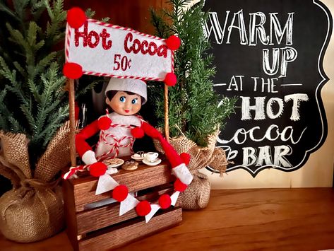 My friend made and let me borrow this amazing hot cocoa stand! Loving it! Paired well with the hot cocoa stand from two years ago Elf Hot Cocoa Bar, Hot Cocoa Elf On The Shelf, Elf Hot Chocolate, Hot Chocolate Stand, Cocoa Stand, Hot Cocoa Stand, Elf Antics, Elf Fun, Hot Cocoa Bar