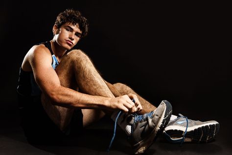 A high school cross country runner pauses a moment as he ties his shoes. This high school senior and cross country runner shows his athleticism and muscle during his photo session. #jenniferbrakephotography #southbendphotographer #seniorsession #seniorguy #portrait #portraitphotography #studiophotography #seniorphotography #studiosession #instudio #highschoolsenior #seniorportrait #crosscountryrunner #crosscountry #athlete Cross Country Portraits, Senior Photos Cross Country, Senior Picture Ideas For Guys Cross Country, Cross Country Photography, Cross Country Senior Pictures Boys, Cross Country Photoshoot, Xc Senior Pictures, Track Senior Pictures Boys, Track And Field Senior Pictures